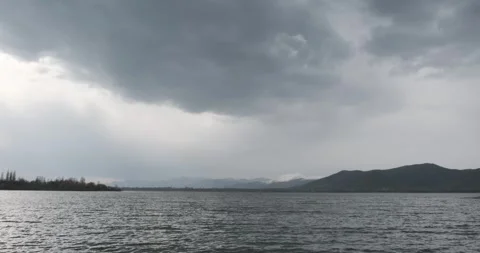 A panoramic view of Mountain Lake Sevan under a cloudy sky. The vastness of the Stock Footage 252466384