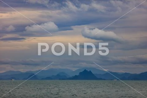 Panoramic view of mountain landscape over sea water with clouds on background Stock Photos