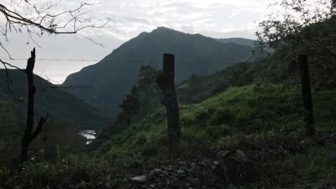Panoramic view of mountain landscape with river and a fence with barbwire Stock Footage 153810055