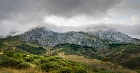 Panoramic view of mountain peaks with clouds on top of the Palencia mountains. Stock Photos