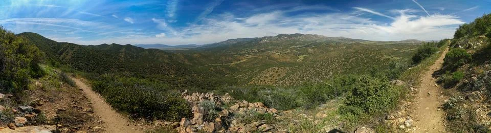 A panoramic view of a mountain range with a clear blue sky Stock Photos