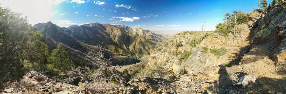 A panoramic view of a mountain range with a clear blue sky Stock Photos
