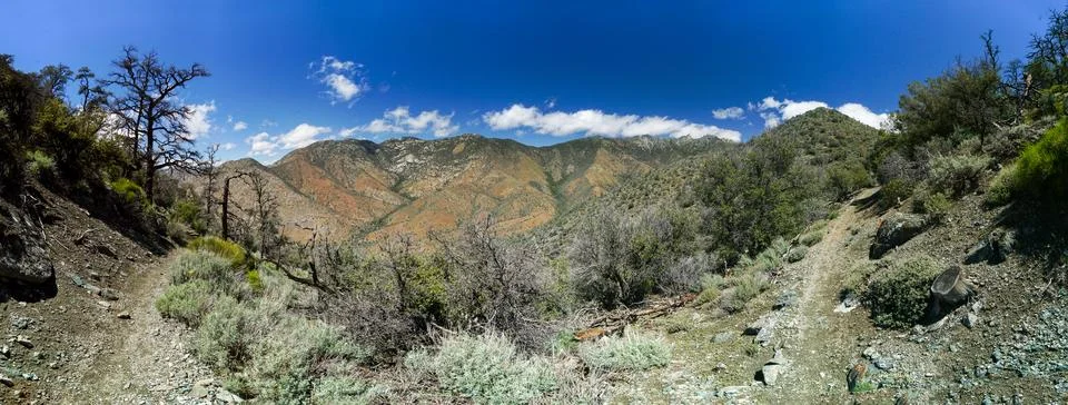 A panoramic view of a mountain range with a clear blue sky Stock Photos