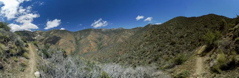 A panoramic view of a mountain range with a clear blue sky Stock Photos