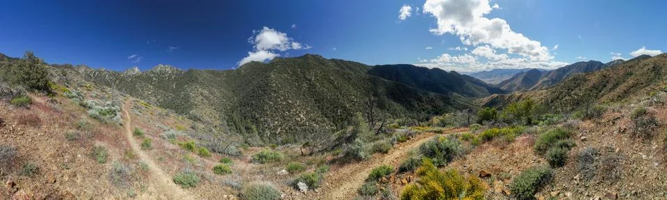 A panoramic view of a mountain range with a clear blue sky Foto stock