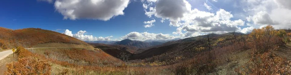 A panoramic view of a mountain range with a cloudy sky Stock Photos