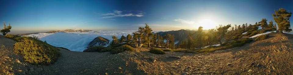 A panoramic view of a mountain range during sunset Stock Photos
