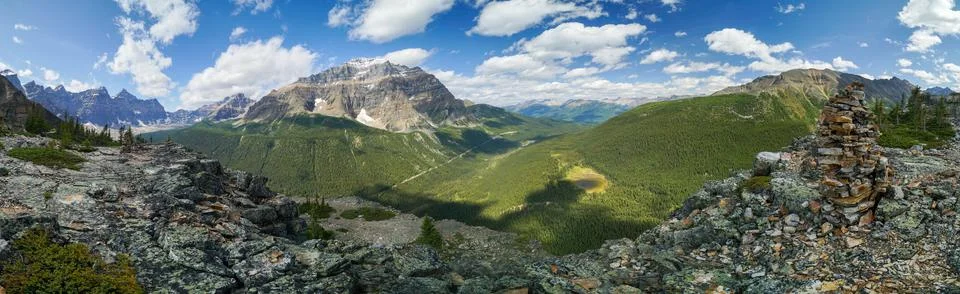 A panoramic view of a mountain range with a large rock on top Stock Photos