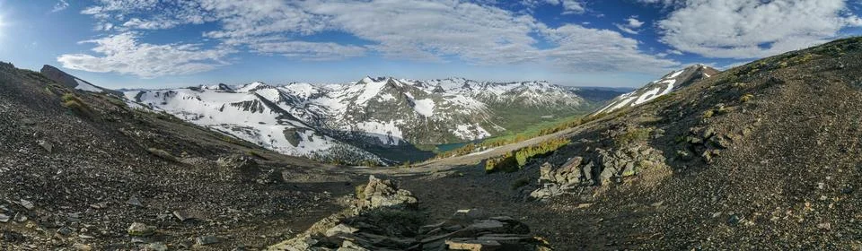 A panoramic view of a mountain range with snow-capped peaks Stock Photos