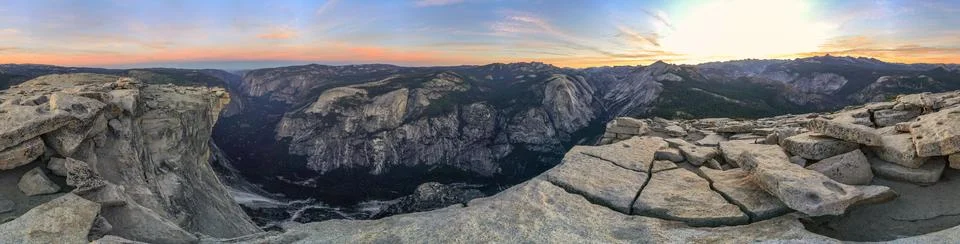 A panoramic view of a mountain range with a sunset in the background Stock Photos