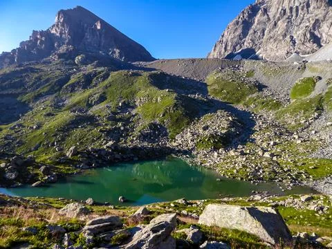 Panoramic view from mountain summit Monte Viso (Monviso) on lake Lago Grand.. Stock Photos