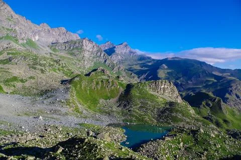 Panoramic view from mountain summit Monte Viso (Monviso) on lake Lago Grand.. Stock Photos