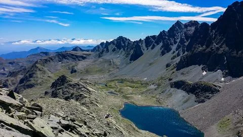 Panoramic view from mountain summit Monte Viso (Monviso) on lake Lago Grand.. Stock Photos