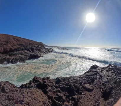 Panoramic view from a mountain top overlooking the volcanic coastline of Stock Photos