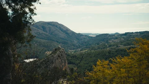 Panoramic view mountain valley with forest and distant sea view 库存影片 333777596