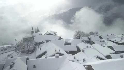 Panoramic view, mountain village after snowfall. Backlights. Video 4K Video stock 239407632