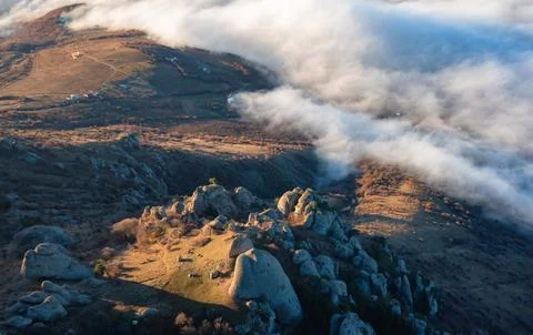 Panoramic view of a mountainous landscape with clouds spreading over villages Stock Photos