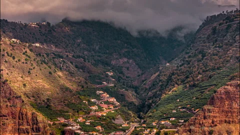 Panoramic view of mountains with clouds and a city in the valley, Madeira. Stock Footage 301382730