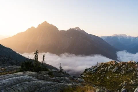 Panoramic view of mountains with a misty cloud inversion during the day. Stock Photos