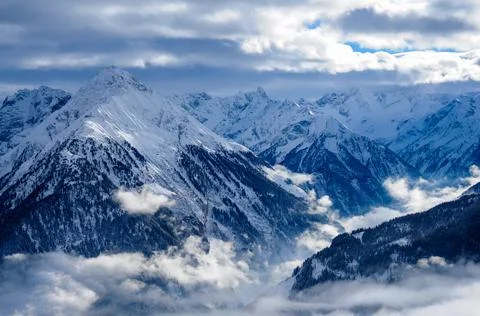 Panoramic view of mountains with snow clouds Stock Photos