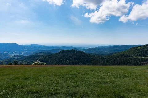 Panoramic view of the mountains under the blue cloudy sky in summer Stock Photos