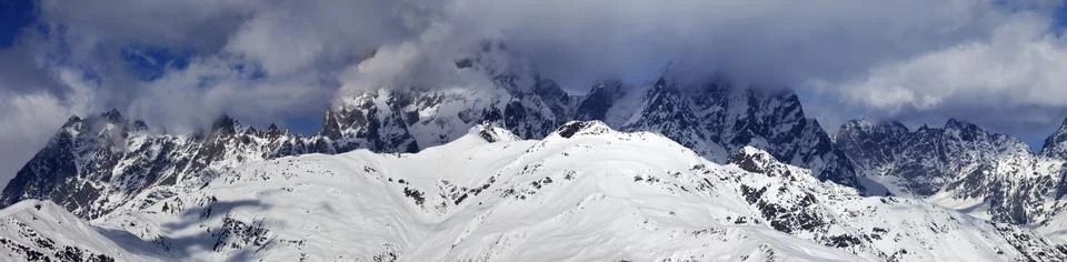 Panoramic view on Mounts Ushba and Chatyn in haze at sunny day Stock Photos