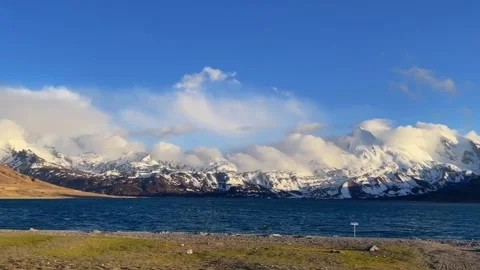 Panoramic View of Namtso Lake and Snow Mountains Under Blue Sky, Tibet 動画素材 337273696