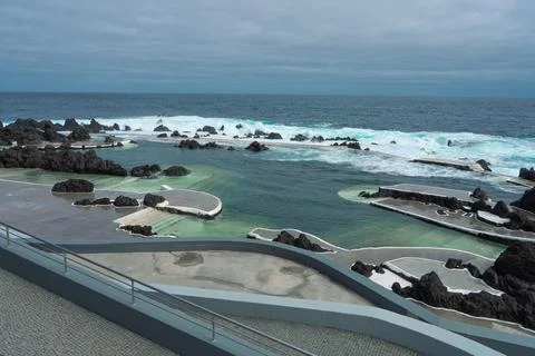 Panoramic view of natural ocean pools carved into volcanic rocks with dynamic Stock Photos