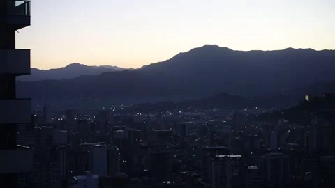 Panoramic view of the night city against the backdrop of mountains Stock Footage 321625112