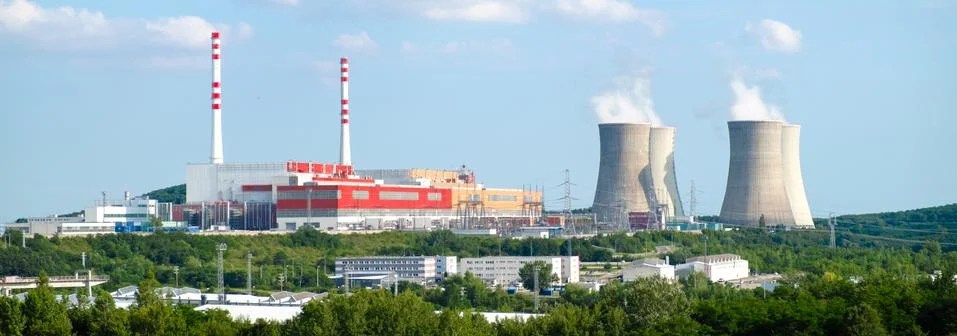 Panoramic view on nuclear power plant with steaming cooling towers on the Stock Photos