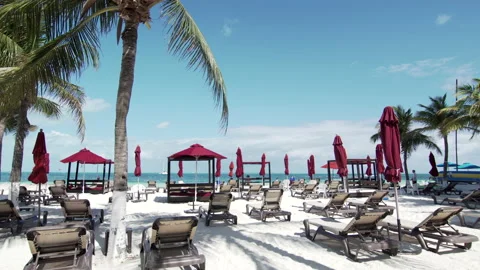 Panoramic view of the ocean beach with parasols and sun loungers on white sand Stock Footage 167848120