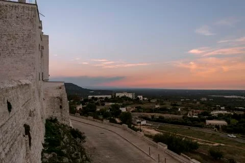 Panoramic view of olive trees plain in front of Ostuni at sunset Stock Photos
