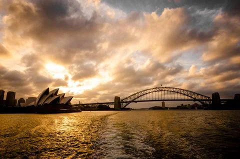 Panoramic view of the Opera House and the Harbour Bridge during sunset Stock Photos