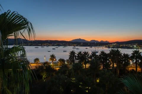 Panoramic view of the orange sunset on the background of the mountains and the Stock Photos