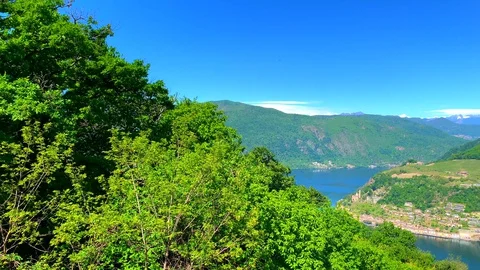 Panoramic View over Alpine Lake and Village Morcote and Mountain in a Sunny Day Stock Footage 129663289