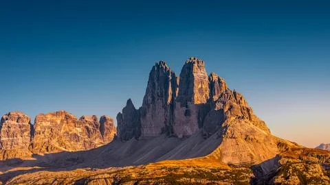 Panoramic view over beautiful sunset in magical Three Dolomite peaks at the n Stock Photos