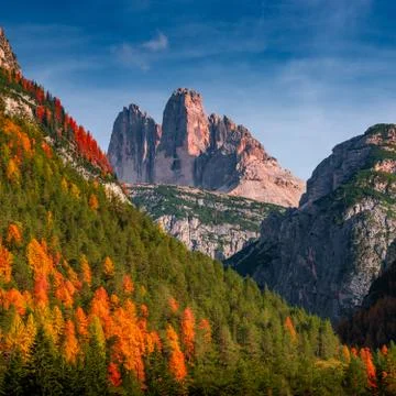 Panoramic view over beautiful sunset in magical Three Dolomite peaks at the n Stock Photos