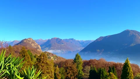 Panoramic View over City of Lugano and Alpine Lake with Mountain in a Sunny Day Видео 165596863