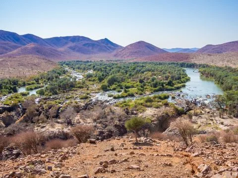 Panoramic view over Kunene River and Epupa Falls at border between Namibia and Stock Photos