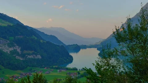 Panoramic View over Lake Lungern and Village with Mountainscape in Valley Stock Footage 276899278
