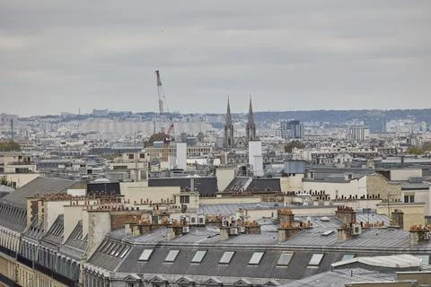 Panoramic view over Paris rooftops with church towers and urban skyline Stockfoto's