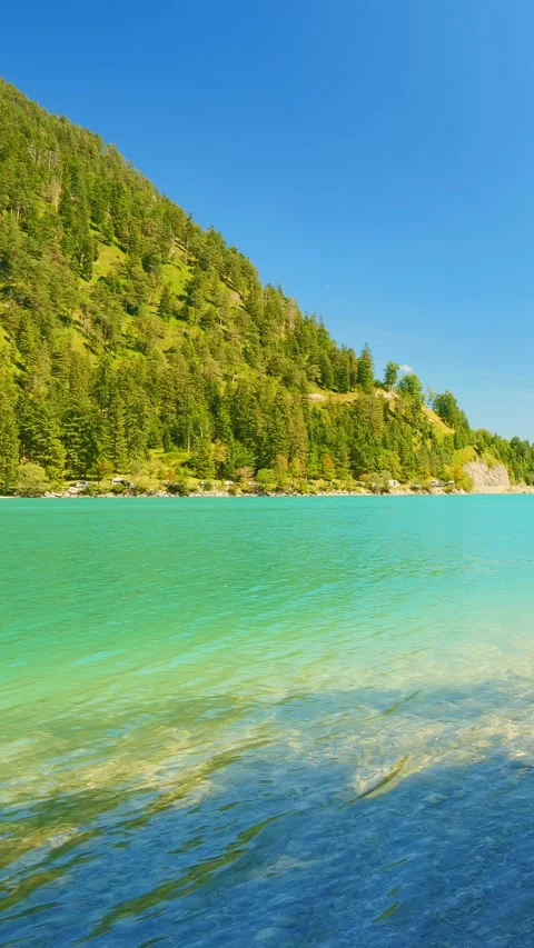 Panoramic view over Plansee lake in Tyrol with vibrant blue water and natural Stock Footage 308877828