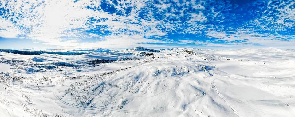Panoramic view over snow capped arctic mountains and wilderness terrain. Stock Photos