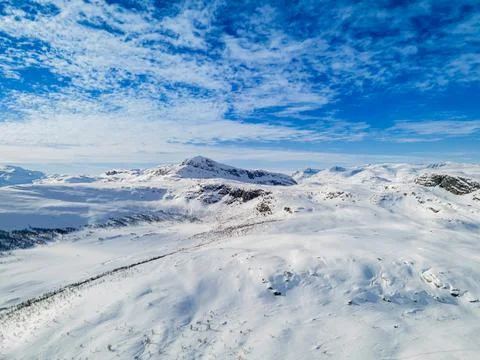 Panoramic view over snow capped arctic mountains and wilderness terrain. Stock Photos