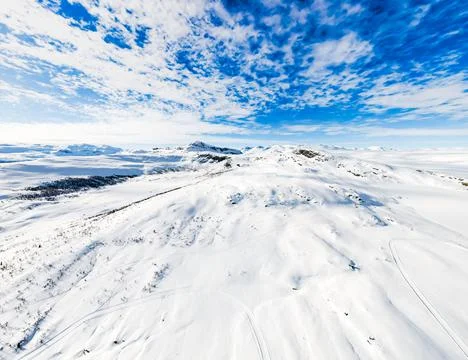 Panoramic view over snow capped arctic mountains and wilderness terrain. Stock Photos