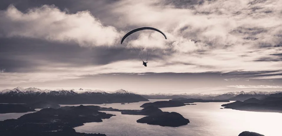 Panoramic view of paragliding over Nahuel Huapi lake and mountains of Bariloche Stock Photos