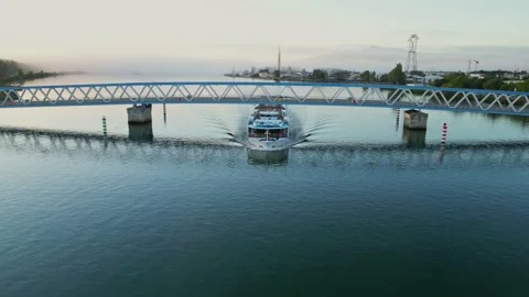 A panoramic view of a passenger ship passing under the bridge on the Rhone River Stock Footage 219589129