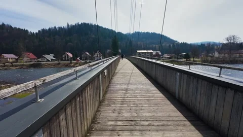 A panoramic view from a pedestrian bridge overlooking a mountain river 스톡 동영상 332156324