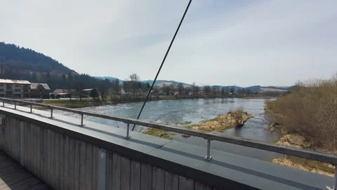 A panoramic view from a pedestrian bridge overlooking a mountain river 스톡 동영상 332156333