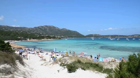 A panoramic view of people relaxing on a beach in the Mediterranean sea Stock Footage 108940177